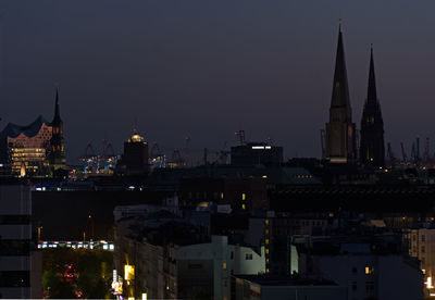 Illuminated buildings in city at night