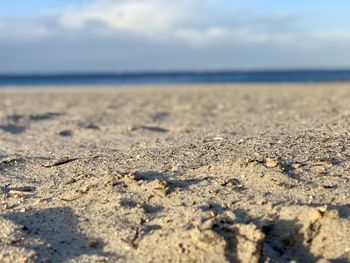 Surface level of sand on beach against sky