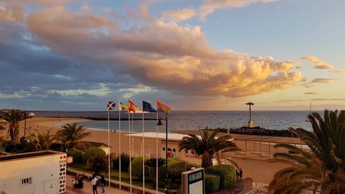 Scenic view of beach against cloudy sky