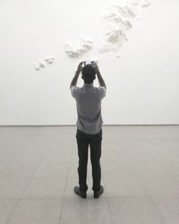 Rear view of man standing against wall