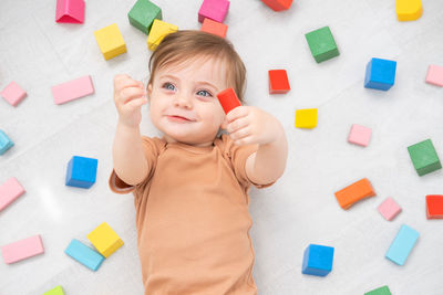 High angle view of boy playing with toy blocks