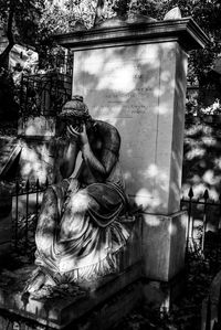 Statue of cemetery against trees