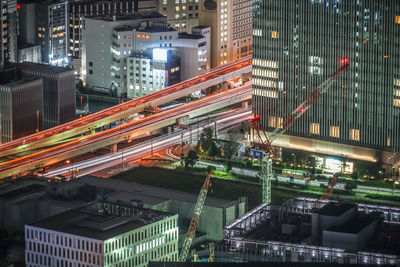 High angle view of illuminated buildings in city at night