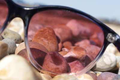 Close-up of sunglasses on pebbles