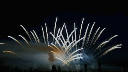 Low angle view of firework display at night