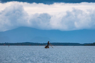 Fisherman fishing in sea