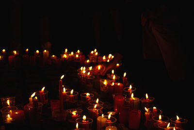 Panoramic view of illuminated candles in temple