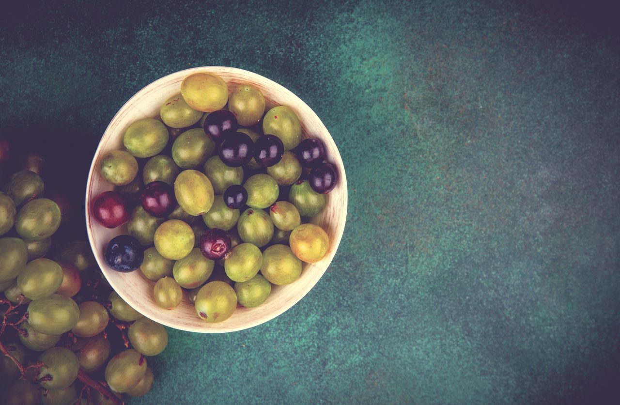 food and drink, food, healthy eating, fruit, wellbeing, freshness, plant, bowl, grape, olive, produce, still life, directly above, table, still life photography, green olive, no people, green, high angle view, indoors, large group of objects, abundance, painting, yellow