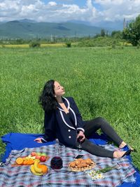 Woman sitting on field