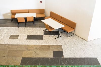 High angle view of empty chairs in building