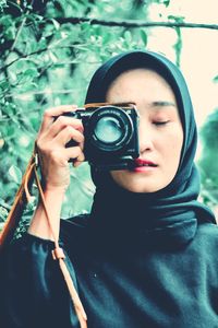 Portrait of woman photographing