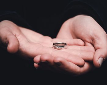 Cropped image of hand holding ring