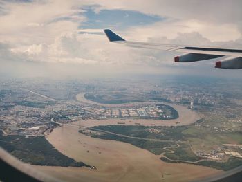 Cropped image of airplane flying over landscape