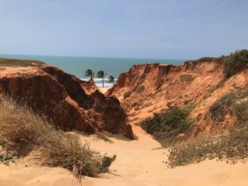 Scenic view of rocks on beach against sky