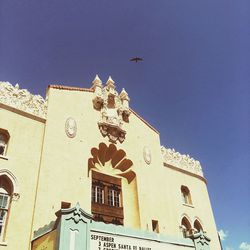 Low angle view of bell tower against blue sky