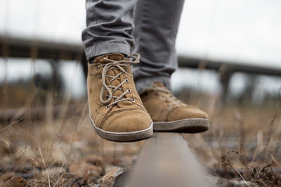 Low section of man wearing shoes standing outdoors