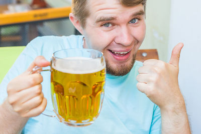 Portrait of smiling man holding drink