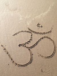 High angle view of text on sand at beach