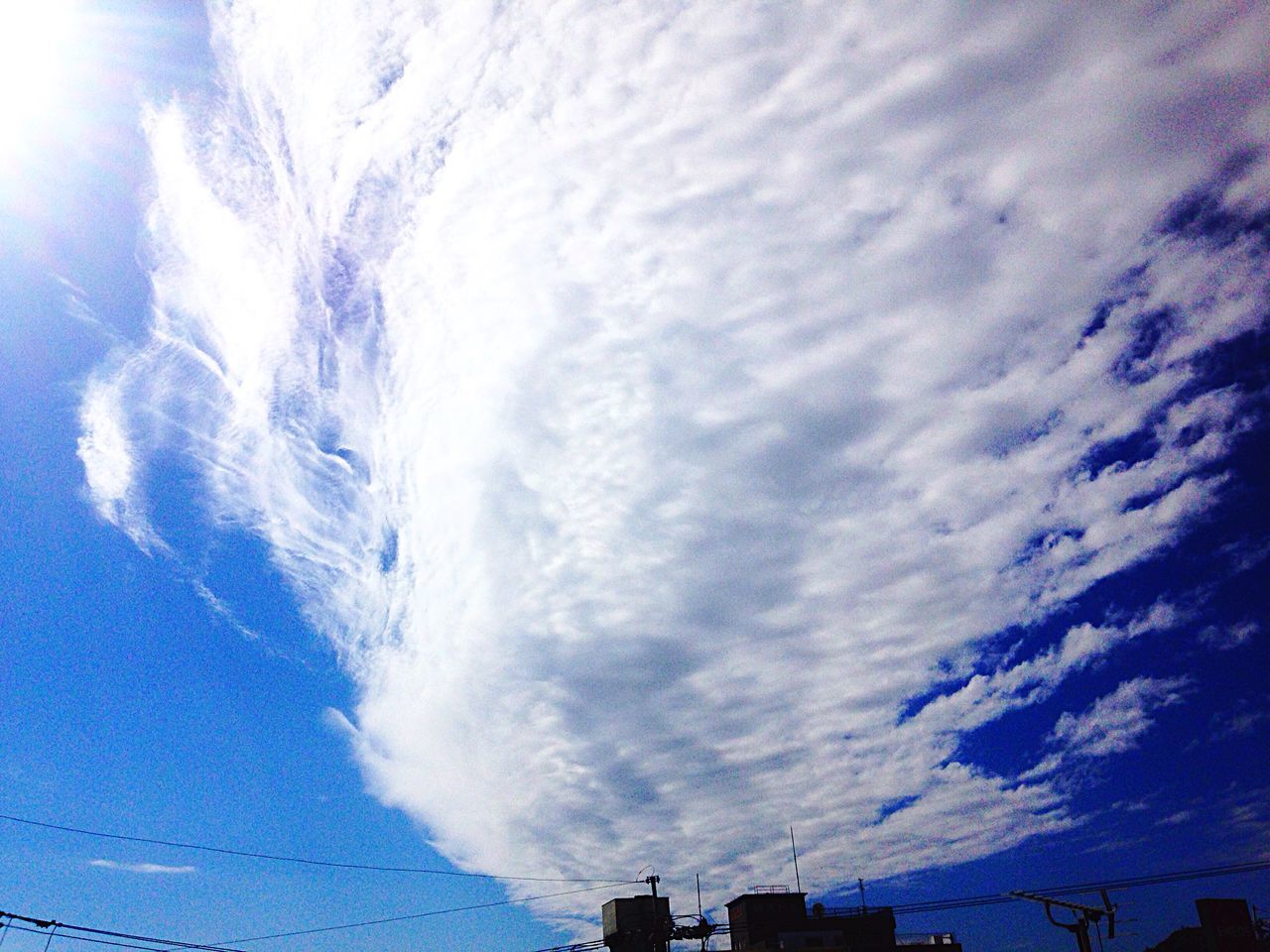 low angle view, sky, cloud - sky, cloudy, weather, building exterior, built structure, architecture, beauty in nature, nature, cloud, high section, blue, scenics, cloudscape, outdoors, tranquility, no people, day, overcast