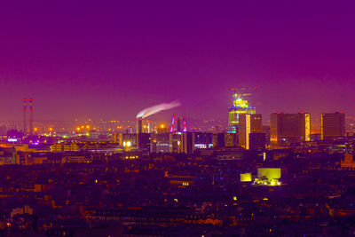 Illuminated city against clear sky at night