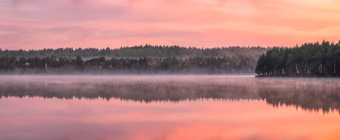 Scenic view of lake against sky at sunset