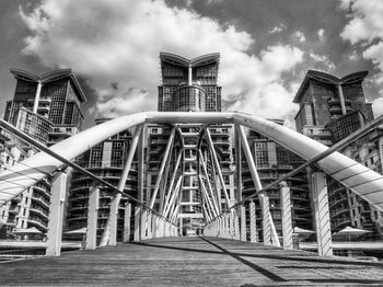 Low angle view of bridge against sky in city