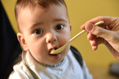 Close-up portrait of cute boy eating 