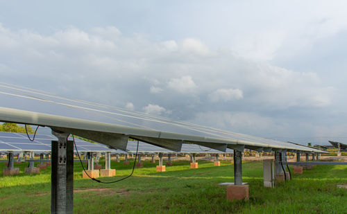 Bridge over field against sky