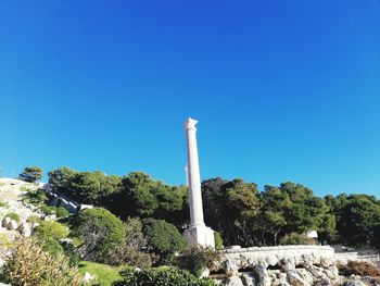 Low angle view of statue against blue sky