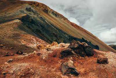 Scenic view of mountain against cloudy sky