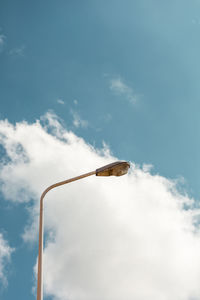 Broken street lamp with a blue sky in the background