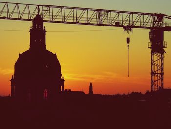 Low angle view of silhouette built structure against sky at sunset