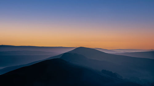 Scenic view of silhouette mountains against sky during sunset