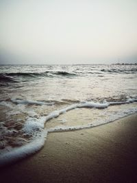 Scenic view of beach against clear sky