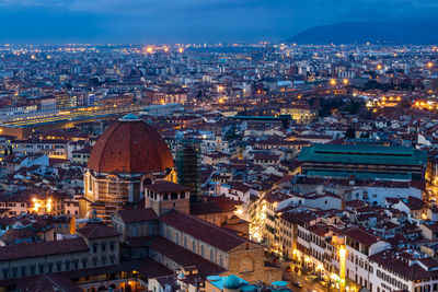 High angle view of city lit up at night