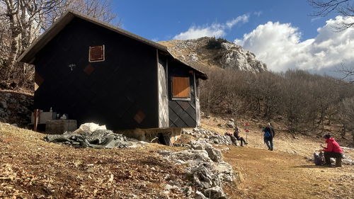 Group of senior hikers in front of mountain shelter