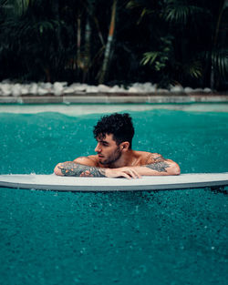 Young man swimming in pool