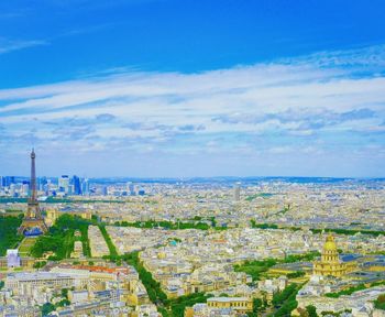 View of cityscape against cloudy sky