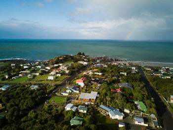 High angle view of townscape by sea against sky