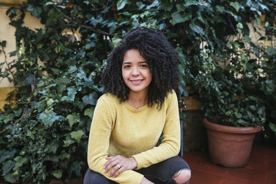 Portrait of a smiling young woman sitting outdoors