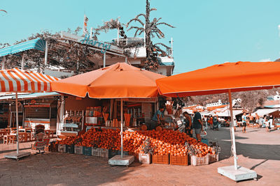 Group of people in market against buildings in city