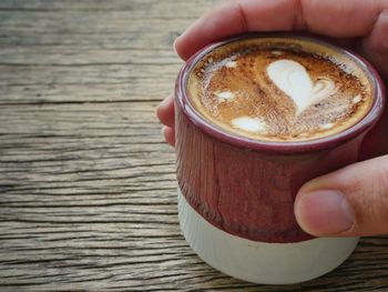 Midsection of person holding coffee cup