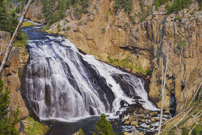 Scenic view of waterfall against sky