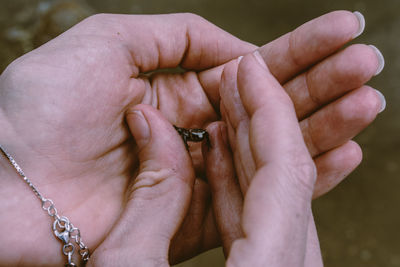 Close-up of couple holding hands