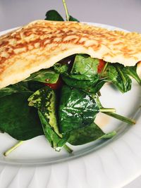 High angle view of spinach omelet in plate on table at home