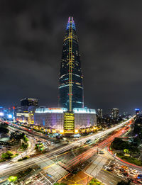 High angle view of illuminated buildings and lotte world tower in city at night