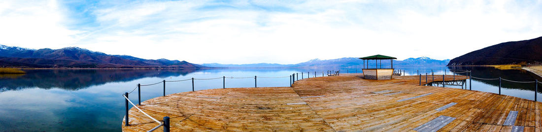 Pier over lake against sky