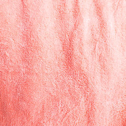 Textures and backgrounds, wrinkled pink towel skin, studio shot.