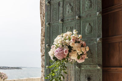 View of flowering plants by window