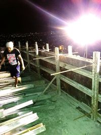 Full length of woman on steps at night